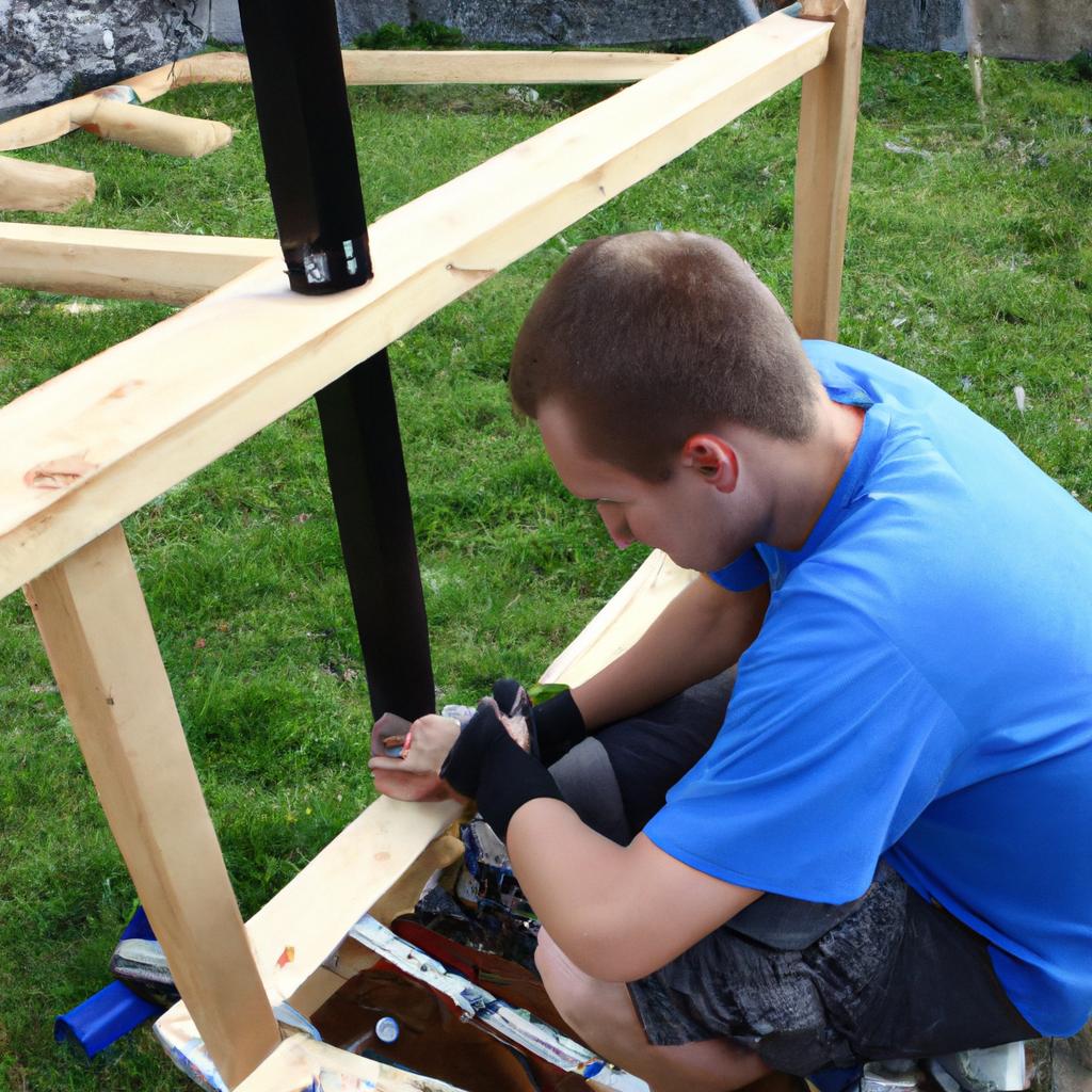 Man assembling climbing frame outdoors